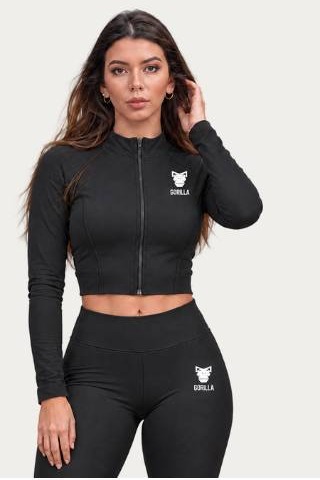 A woman in a black Gorilla zip jacket and leggings